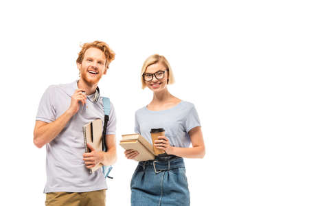 Students looking at camera while holding books, coffee to go and headphones isolated on white