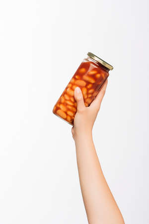 cropped view of woman holding canned beans isolated on white, charity conceptの写真素材