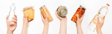 cropped view of woman hands with food isolated on white, charity conceptの写真素材