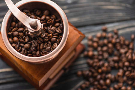 selective focus of vintage coffee grinder with coffee beans