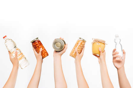 cropped view of woman hands with food isolated on white, charity conceptの写真素材