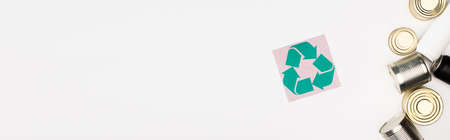 Horizontal crop of card with recycle sign and steel cans on white surface, ecology concept