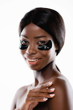african american naked woman with hydrogel eye patches on face isolated on whiteの写真素材