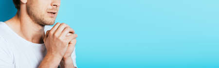 Horizontal crop of scared man on blue background with copy spaceの写真素材