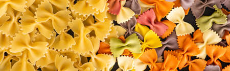 top view of raw colorful fusilli and farfalle pastaの写真素材