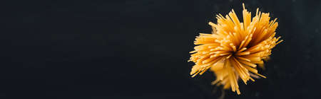 top view of raw Italian spaghetti isolated on black, panoramic shotの写真素材