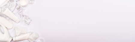 top view of plastic rubbish scattered on white background with copy space, panoramic shot