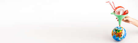 cropped view of man holding funnel with plastic above globe on white background, panoramic shot