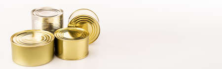 metal golden tins on white background, panoramic shotの写真素材