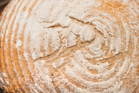 close up view of fresh baked bread crust with flour