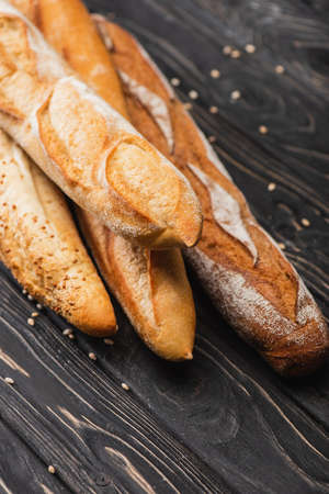 fresh baked baguette loaves on wooden surface