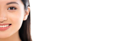 Panoramic shot of excited young asian woman looking at camera isolated on whiteの写真素材