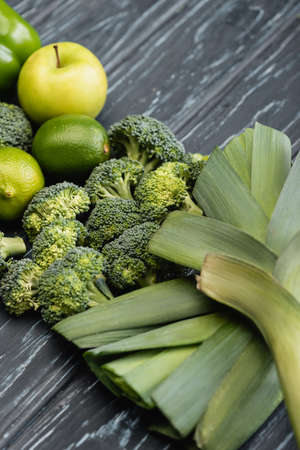 fresh green ripe fruits and vegetables on wooden surfaceの写真素材