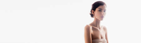 panoramic crop of brunette young woman looking at camera isolated on whiteの写真素材