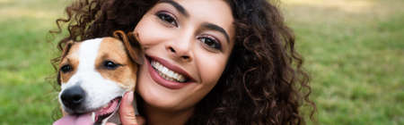 Panoramic crop of young woman with jack russell terrier dogの写真素材