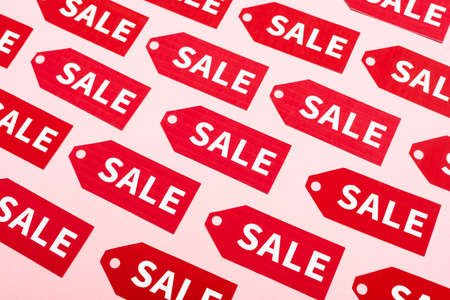 top view of labels with sale lettering on pink, black friday conceptの写真素材