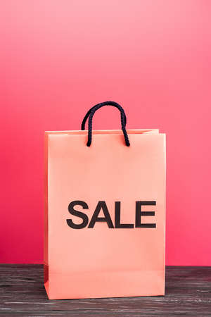 shopping bag with sale lettering on pink, black friday conceptの写真素材