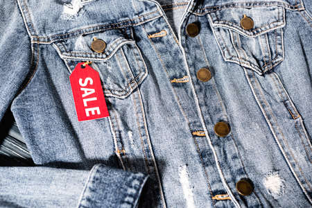 close up of red sale tag on blue denim jacket, black friday conceptの写真素材