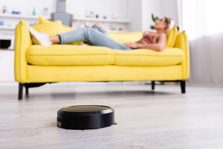 Selective focus of robotic vacuum cleaner on floorの写真素材