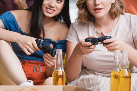 KYIV, UKRAINE - JULY 28, 2020: selective focus of women playing video game during partyのeditorial素材