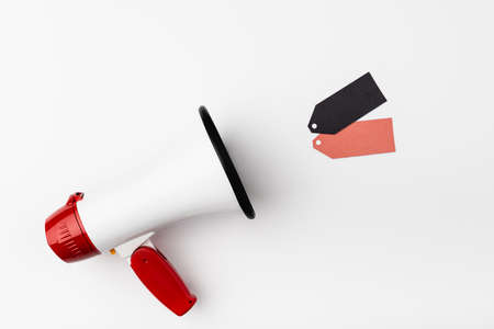 Top view of loudspeaker near empty price tags on white backgroundの写真素材