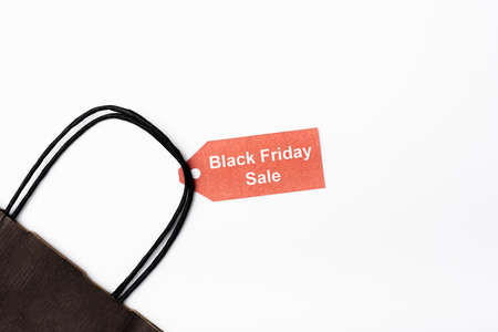 Top view of shopping bag and price tag with black friday sale lettering on white backgroundの写真素材