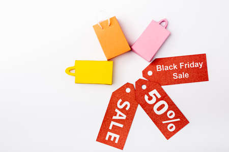 Top view of toy shopping bags and price tags with black friday sale on white backgroundの写真素材
