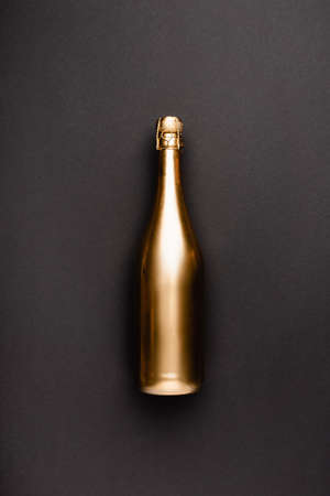 Top view of golden bottle of champagne on black backgroundの写真素材