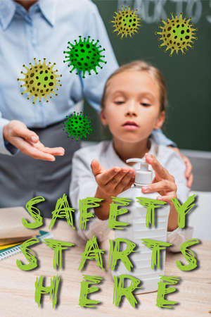selective focus of schoolgirl applying hand sanitizer near teacher and safety starts here lettering...