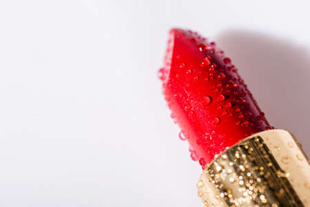 close up view of red wet lipstick on white backgroundの写真素材