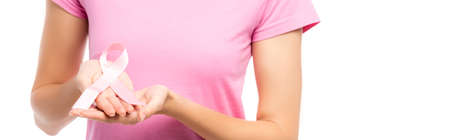 Panoramic orientation of young woman showing pink ribbon isolated on whiteの写真素材