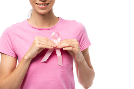 Cropped view of young woman holding breast cancer awareness ribbon isolated on whiteの写真素材