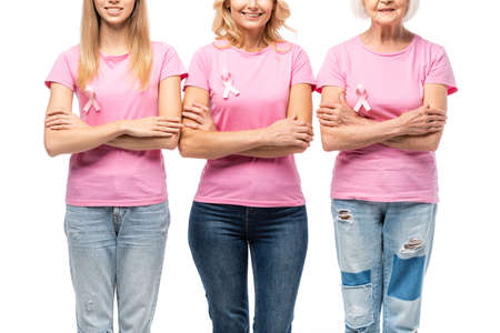 Cropped view of women with pink ribbons of breast cancer awareness isolated on whiteの写真素材