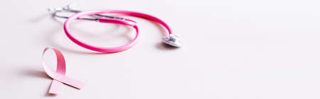 Panoramic shot of stethoscope and pink ribbon isolated on whiteの写真素材