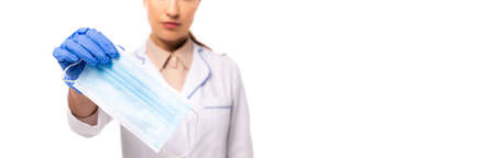 Panoramic crop of doctor in latex glove showing medical mask isolated on whiteの写真素材