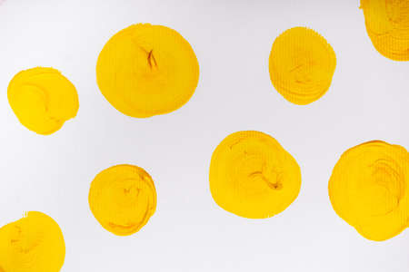 top view of abstract colorful yellow painted circles on white backgroundの写真素材