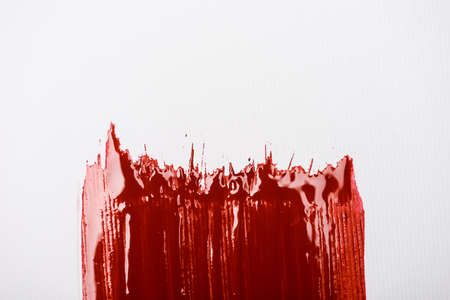 top view of colorful red paint brushstroke on white backgroundの写真素材