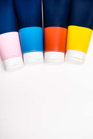top view of acrylic paint tubes on white background