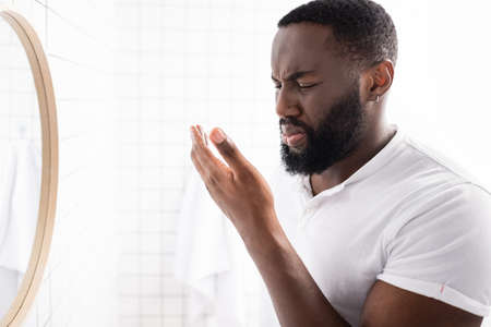 afro-american man breathing bad smell from mouthの写真素材