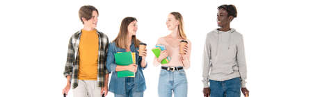 Panoramic shot of smiling multiethnic teenagers with books and coffee to go isolated on white