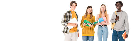 Panoramic orientation of smiling multicultural teenagers with books and laptop looking at camera...