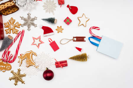 top view of different christmas baubles, candy canes and cookies on white backgroundの写真素材
