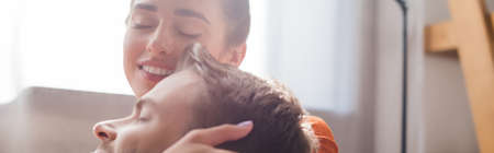 tender, smiling woman touching head of beloved man with closed eyes, banner