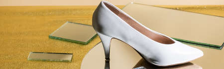 elegant white heeled shoe on mirror surface, bannerの写真素材