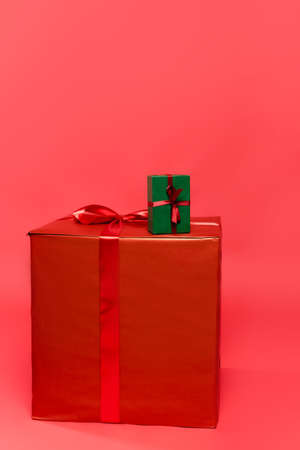 Gift boxes with ribbons on red background