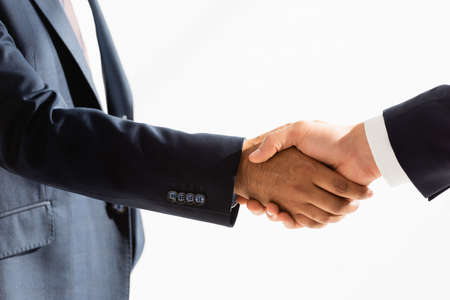 partial view of politicians shaking hands on whiteの写真素材