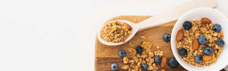 top view of delicious granola with nuts, blueberry and dried apricots isolated on white, bannerの写真素材