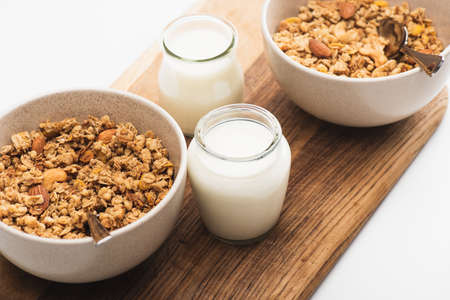 delicious granola with nuts and yogurt isolated on whiteの写真素材