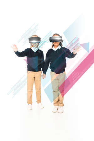 full length view of multicultural schoolgirls holding hands while using virtual reality headsets on white background, abstract illustrationの写真素材