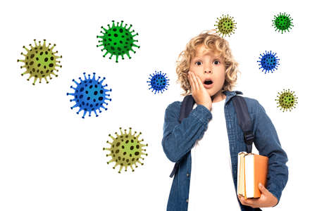 shocked blonde schoolkid touching face and holding books near viruses illustration on whiteの写真素材
